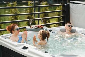 In summer, the family rests in the outdoor hot tub photo