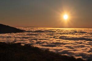 a spectacular sunset above the clouds in the national Park of the volcano Teide on Tenerife. Excellent sunset in the Canary Islands photo