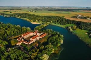 Aerial photo Nesvizh castle in autumn evening, Belarus Minsk, top view