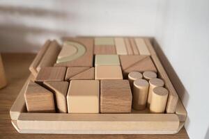 A shelf with children's wooden toys in the children's room. Children's concept photo