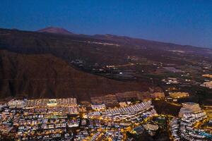 Top view of the houses located on the rock of Los Gigantes at sunset, Tenerife, Canary Islands, Spain photo