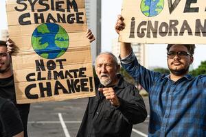 Multiracial activists protesting for climate change - Global warming demonstration concept photo