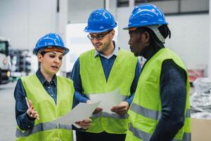 Team of multiracial engineers working in robotic factory - Tech industry concept photo