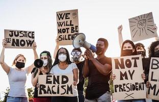 Activist movement protesting against racism and fighting for equality - Demonstrators from different cultures and race protest on street for equal rights - Black lives matter protests city concept photo