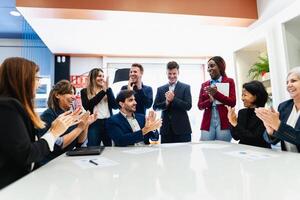 Group of multigenerational business team celebrating success in the office - Businesspeople with diverse age and ethnicity concept photo