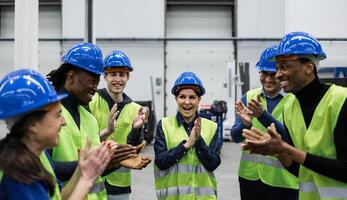 Team of multiracial engineers working in robotic factory - tech industrial concept photo