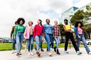 Group of young multiracial friends having fun hanging out together in the city - Friendship and diversity concept photo