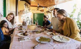 Happy Latin family having fun lunching together at home photo