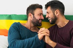 Happy gay couple having tender moments in bedroom - Homosexual love relationship and gender equality concept photo