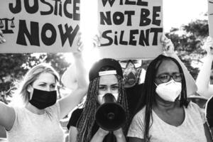 Activist movement protesting against racism and fighting for equality - Demonstrators from different cultures and race protest on street for equal rights - Black lives matter protests city concept photo