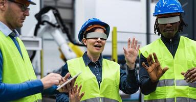 Team of engineers having simulation experience with futuristic virtual reality glasses inside robotic factory - Tech industry and metaverse concept photo