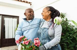 Happy African senior people gardening together at home photo