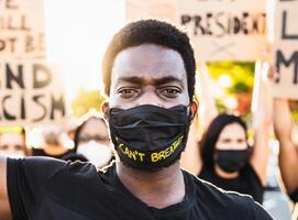 Black lives matter activist movement protesting against racism and fighting for equality - Demonstrators from different cultures and race protest on street for justice and equal rights photo