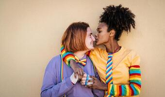 Multiracial lesbian couple celebrating gay pride day - Lgbt and love relationship concept photo