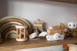 A shelf with children's wooden toys in the children's room. Children's concept photo