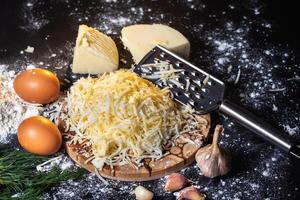 preparation of the process of cooking cheese balls with garlic and dill on a black background photo