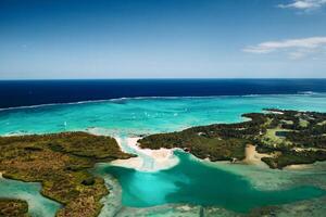 Aerial picture of the east coast of Mauritius Island. Beautiful lagoon of Mauritius Island shot from above. Boat sailing in turquoise lagoon photo