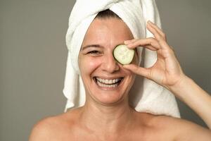 Happy mature woman having skin care spa day - People wellness lifestyle concept photo