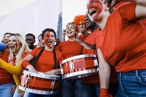 Football fans having fun cheering their favorite team - Soccer sport entertainment concept photo