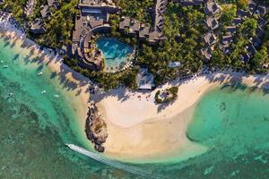 View from the height of the east coast of the island of Mauritius. Flying over the turquoise lagoon of the island of Mauritius in the area of Bel Mare. photo