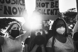 Black lives matter activist movement protesting against racism and fighting for equality - Demonstrators from different cultures and race protest on street for justice and equal rights photo