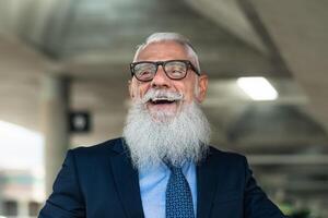 Portrait of happy fashion senior man going to work in office - Elderly people lifestyle concept photo