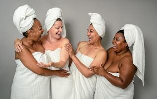 Happy multiracial females with different body size having skin care spa day - People selfcare concept photo