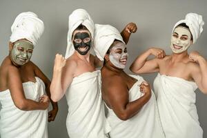 Happy multiracial females with different age and body size having skin care spa day - People selfcare concept photo