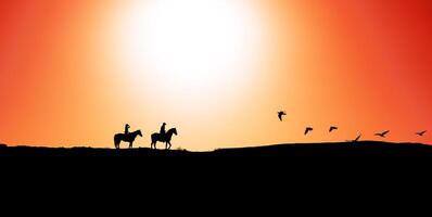 Young people riding horses at sunset time - Horseback travel people having fun exploring wild nature - Animals passion and equestrian lifestyle concept photo