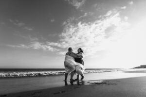 Happy plus size women having fun on the beach during summer vacation - Curvy confident people lifestyle concept - Black and white editing photo