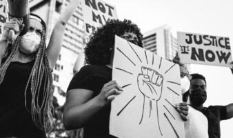 Black lives matter international activist movement protesting against racism and fighting for justice - Demonstrators from different cultures and race protest on street for equal rights photo