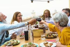 a group of people toasting at a dinner table photo