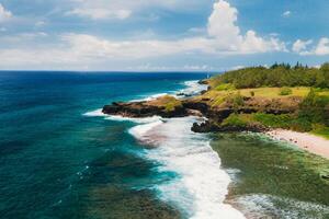 View of the famous Golden beach between black volcanic rocks on the banks of the Gris-Gris river, La Roche qui pleure in Mauritius photo