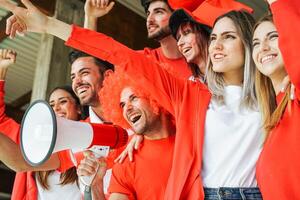 Football Supporter fans watching international match - Young group of excited friends having fun supporting the soccer world game at stadium - Youth, sport and celebration score concept photo