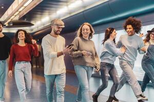 Group young friends having fun in subway underground metropolitan - Happy trendy people sharing time and laughing together - Youth millennial friendship lifestyle concept photo