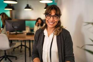 Happy Latin woman in coworking creative space photo