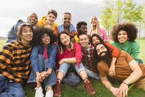 Group of young multiracial friends having fun together in park - Friendship and diversity concept photo