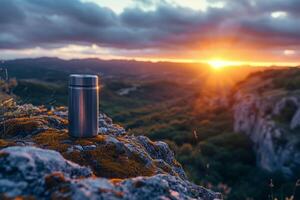 ai generado un al aire libre termo matraz soportes en un rock a puesta de sol foto