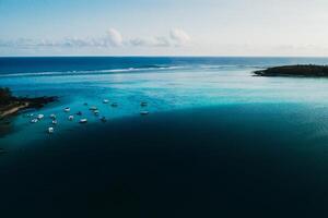 Aerial picture of the east coast of Mauritius Island. Beautiful lagoon of Mauritius Island shot from above. Boat sailing in turquoise lagoon photo