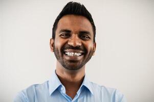 Happy business Indian man smiling in camera inside office photo