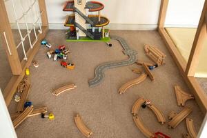 A scattered wooden road construction kit on the floor. Child's play photo
