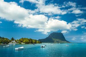 View of the mountain in Le Morne Brabant and the bay with boats on the island of Mauritius in the Indian Ocean photo