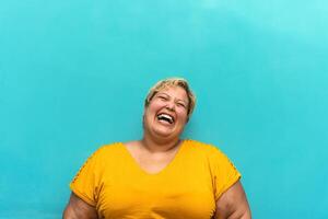 Happy plus size woman portrait - Curvy overweight model having fun smiling at camera - Over size confident person concept photo