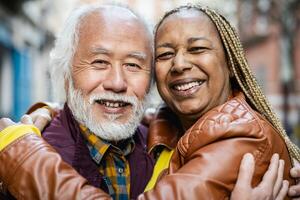 Happy multiracial senior couple portrait - Elderly people lifestyle and love relationship concept photo