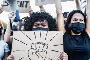 Black lives matter international activist movement protesting against racism and fighting for justice - Demonstrators from different cultures and race protest on street for equal rights photo