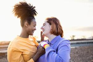 Happy women gay couple having tender moments during sunset outdoor - Lgbt and love relationship concept photo