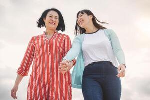 Happy Asian mother and daughter having fun outdoor - Chinese family spending time together outside - Love  relationship people and parenthood lifestyle concept photo