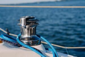 rope on the winch of a white yacht in the sea.yacht equipment photo