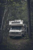 AI generated Camping in the forest of the motorhome . Holidays in a camper van photo