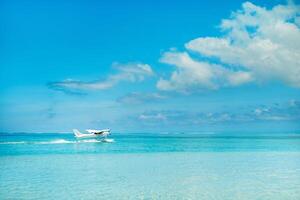 Seaplane begins to take off on the island of Mauritius in the Indian Ocean photo